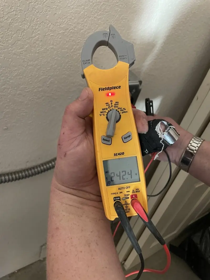 Voltage testing with clamp meter during Recessed Lighting Installation in Wahpeton